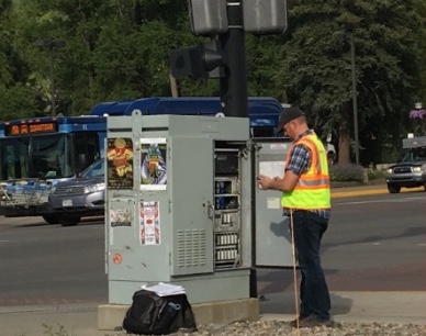 Alex Larson reviewing operations at a traffic signal cabinet.